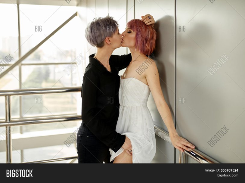 Blonde and brunette kiss