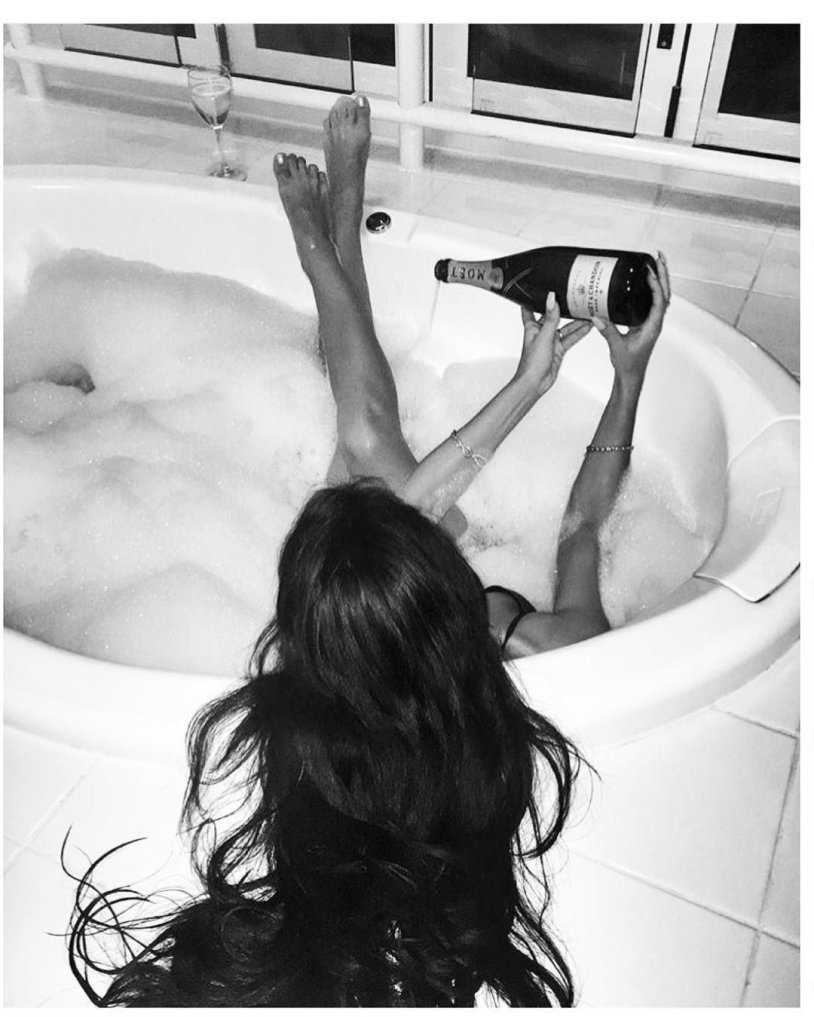 Girl in the bathroom with champagne