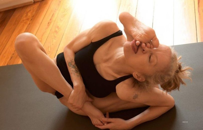 Naked gymnasts legs behind the head