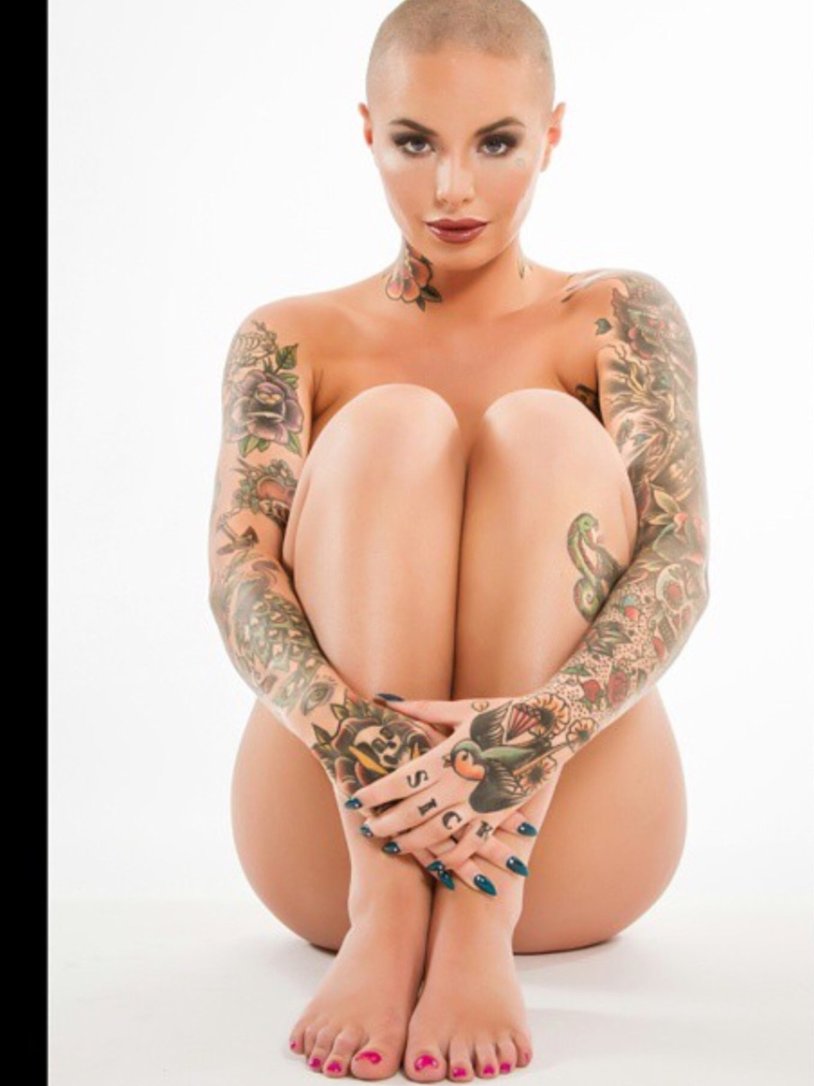 Naked bald girl with tattoos