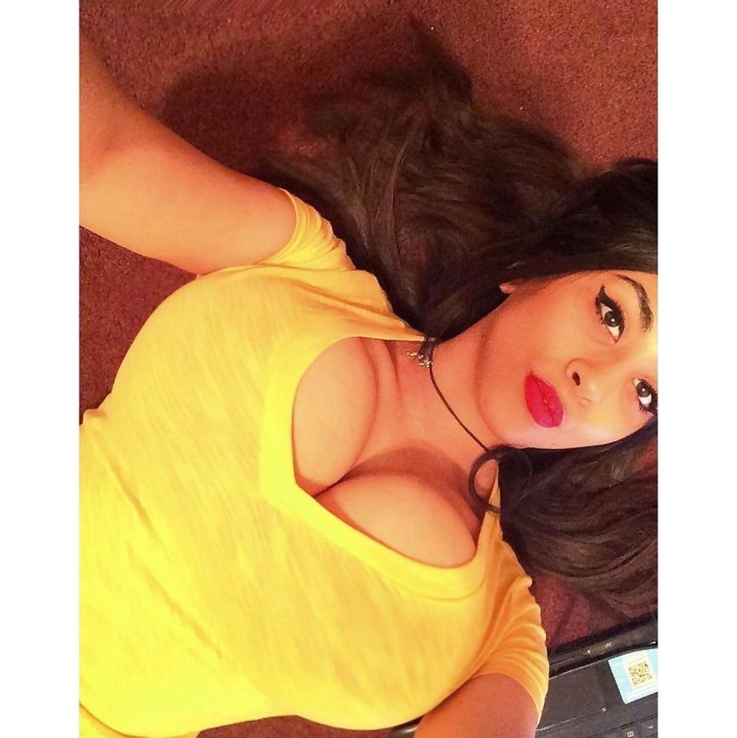 Naked brunette in heels lies