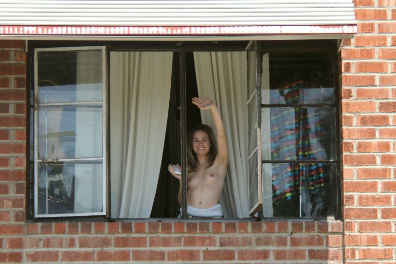 Shows tits in the window