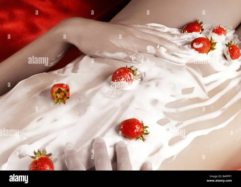 Cream with strawberries on a girl
