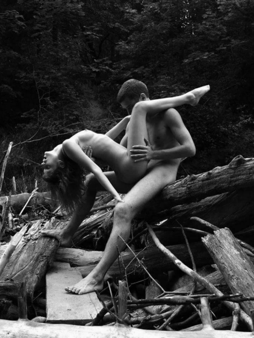 Naked men and women in the forest