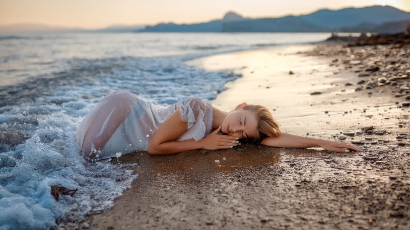 Girl lies in the sand