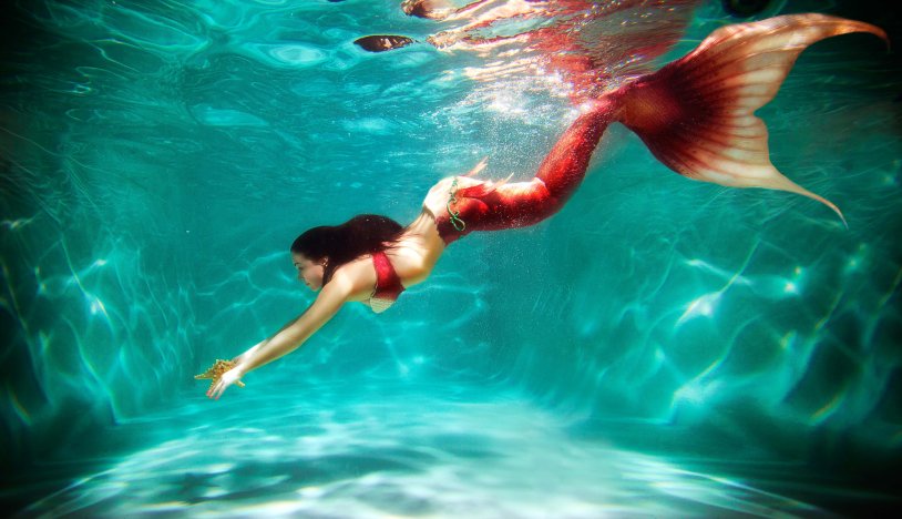 The girl is floating under water