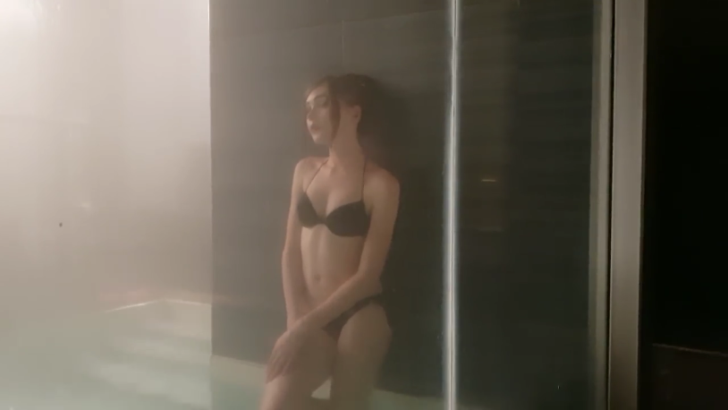 Karina Strimmersha in a swimsuit in a sauna