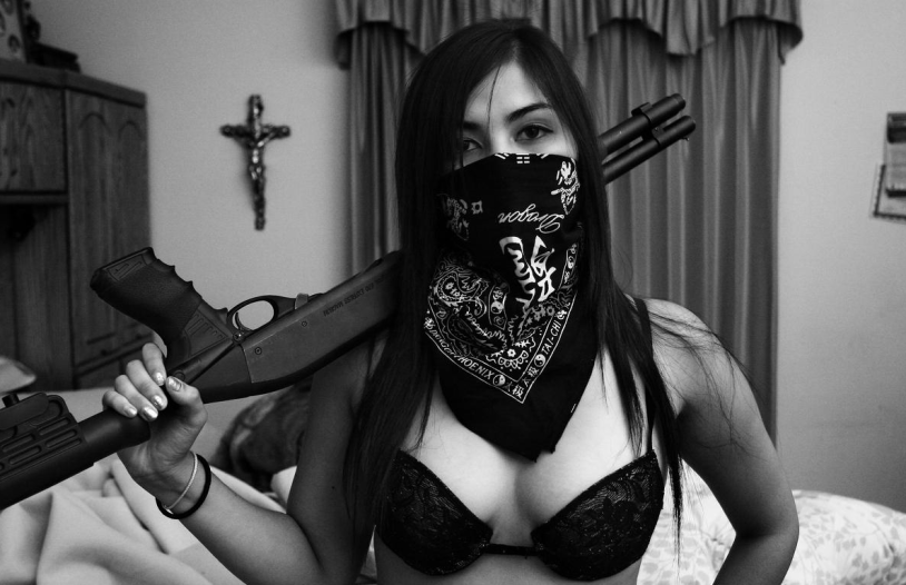 Girl in a mask with a gun