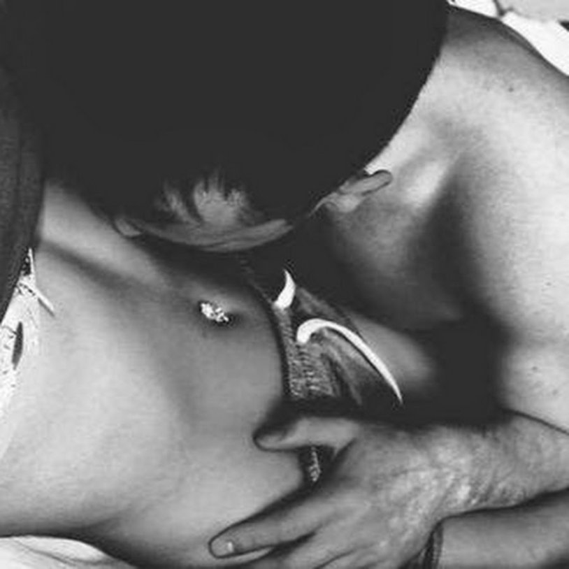 The guy kisses the girl in the tummy