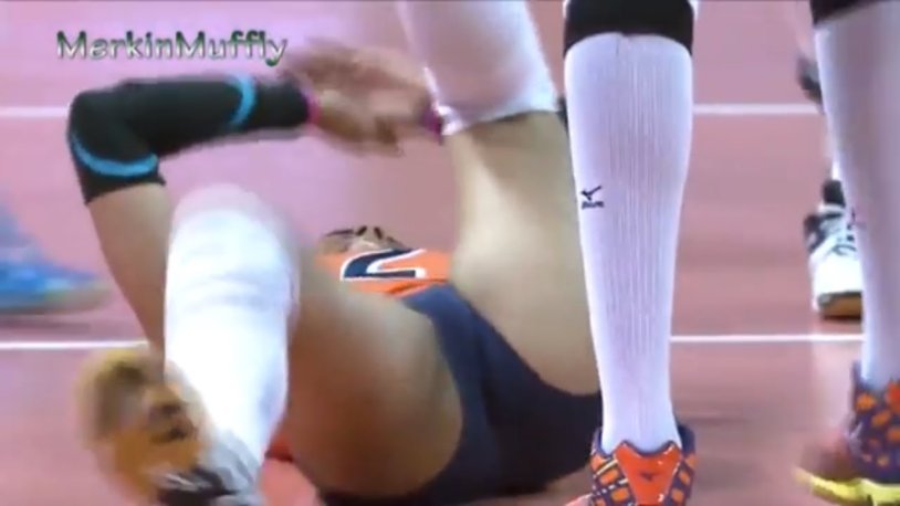 Girls in a worship near a volleyball mesh