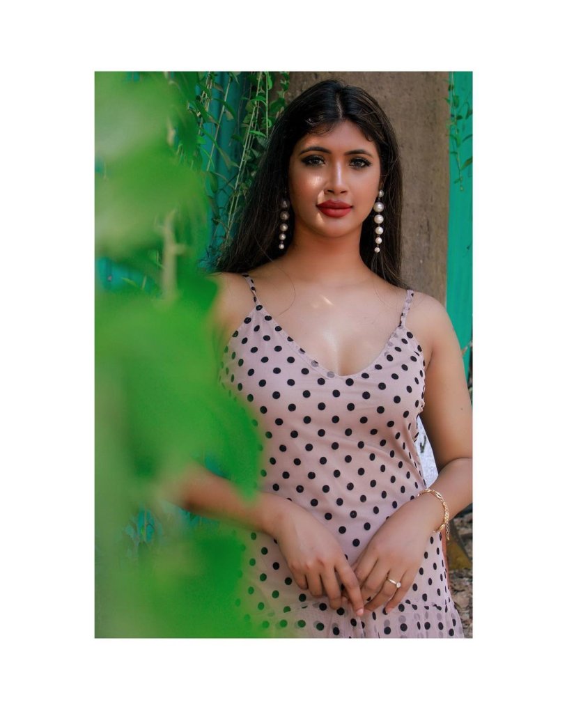 Beautiful brown -haired manner in a dress is exposed in nature