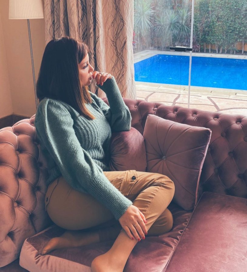 Woman sits on the couch