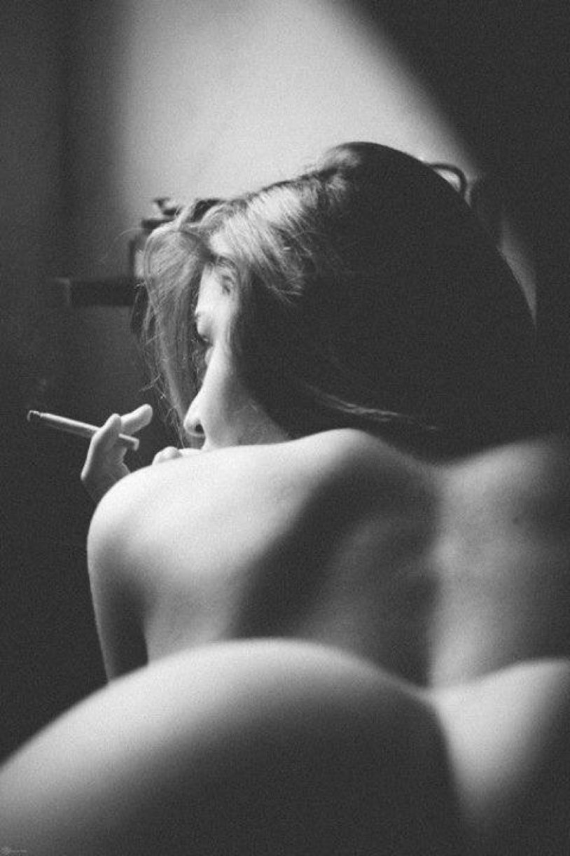 The girl smokes erotically