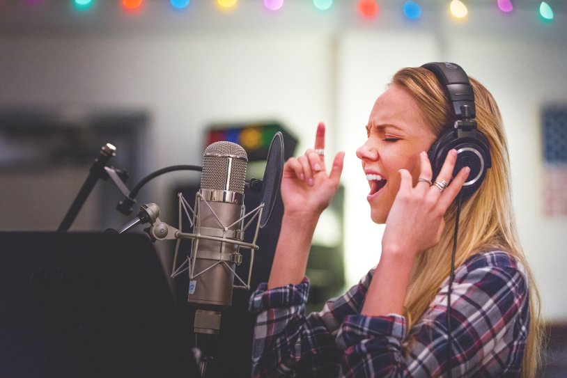 The girl sings in sound recording studio