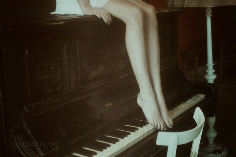 Women's legs on the piano