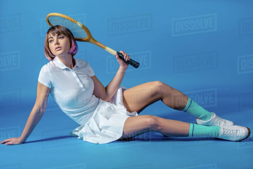 Tennis player sits with a racket