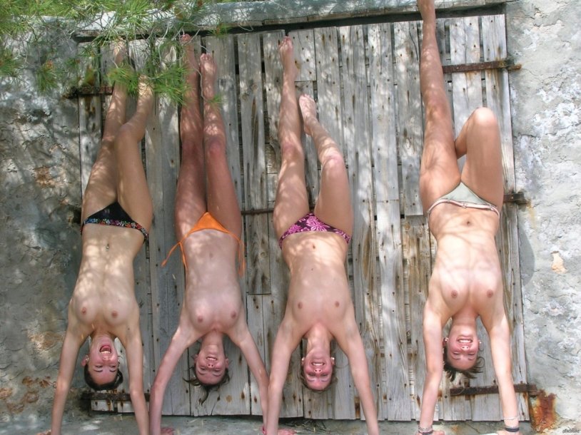 Naked women hang upside down