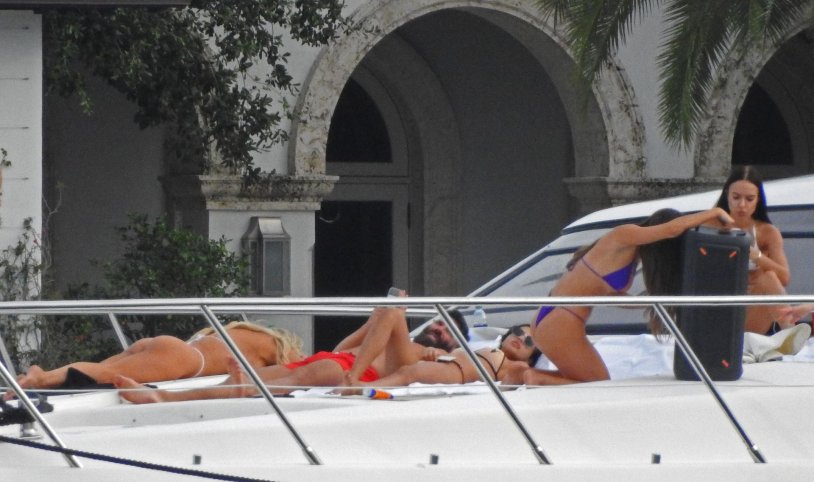 The girl sunbathes on a yacht