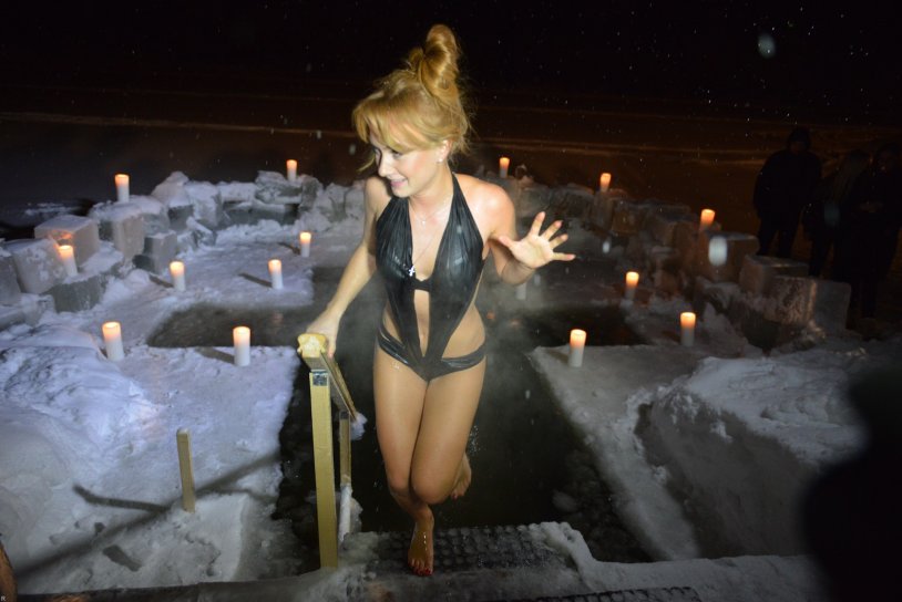 Bathing in the hole for the baptism of the girl