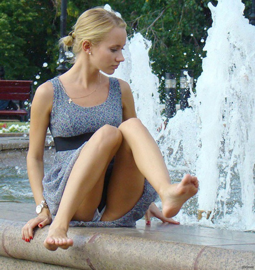Girl in a fountain in shorts