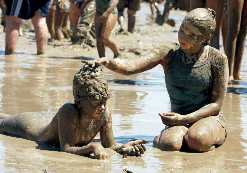 Women swim in the mud