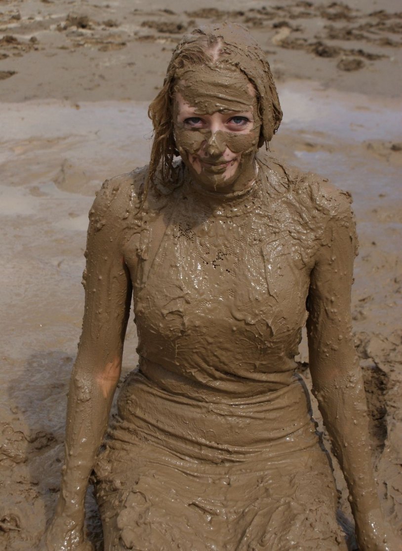 Woman is lying in the mud