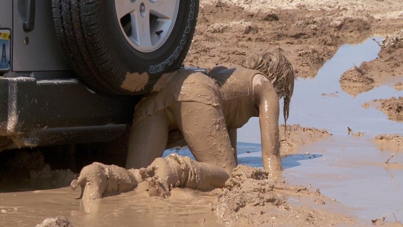 Girl in a jeep in mud