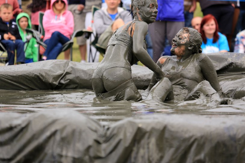 Girls swim in the mud