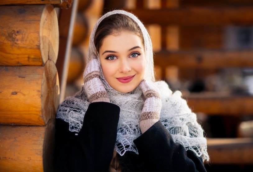 Girl in mittens and scarf blowing