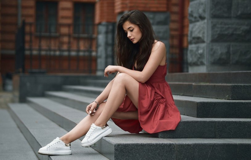 Girl in a dress sits