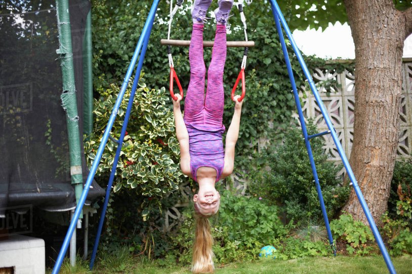 WIMAN CLIMBING AND UPSIDE DOWN ON CLIMBING FRAME