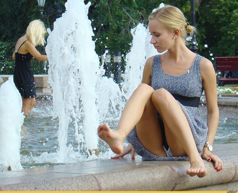 Girl in a fountain in shorts