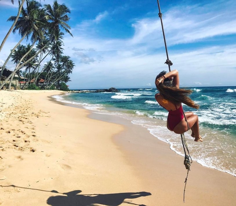 Girl on a swing on the beach