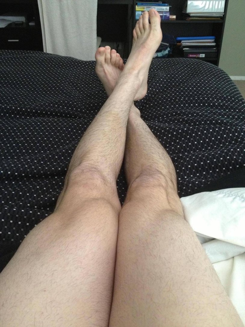 Male legs on the bed