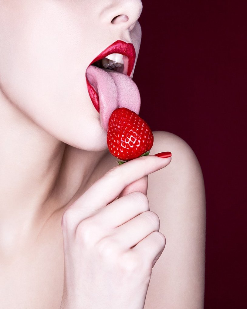 The girl eats strawberries