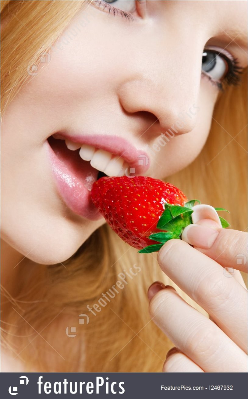 The girl eats strawberries