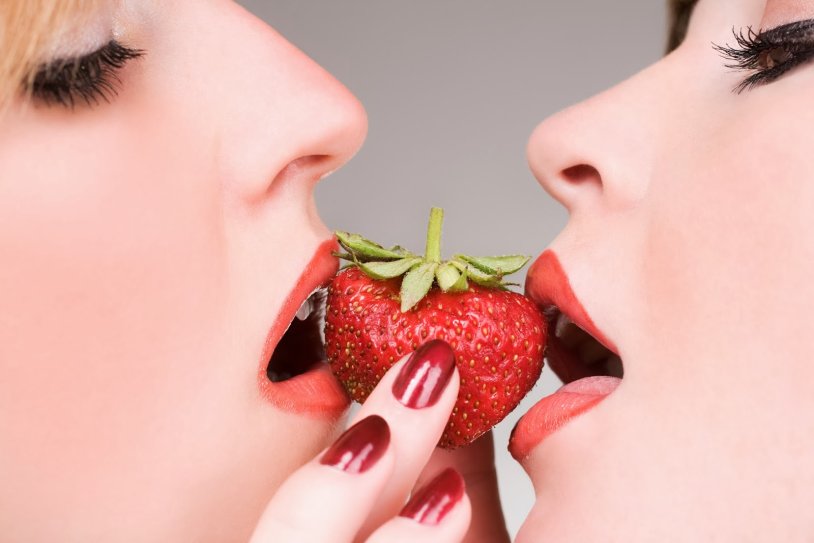 The guy licks strawberries