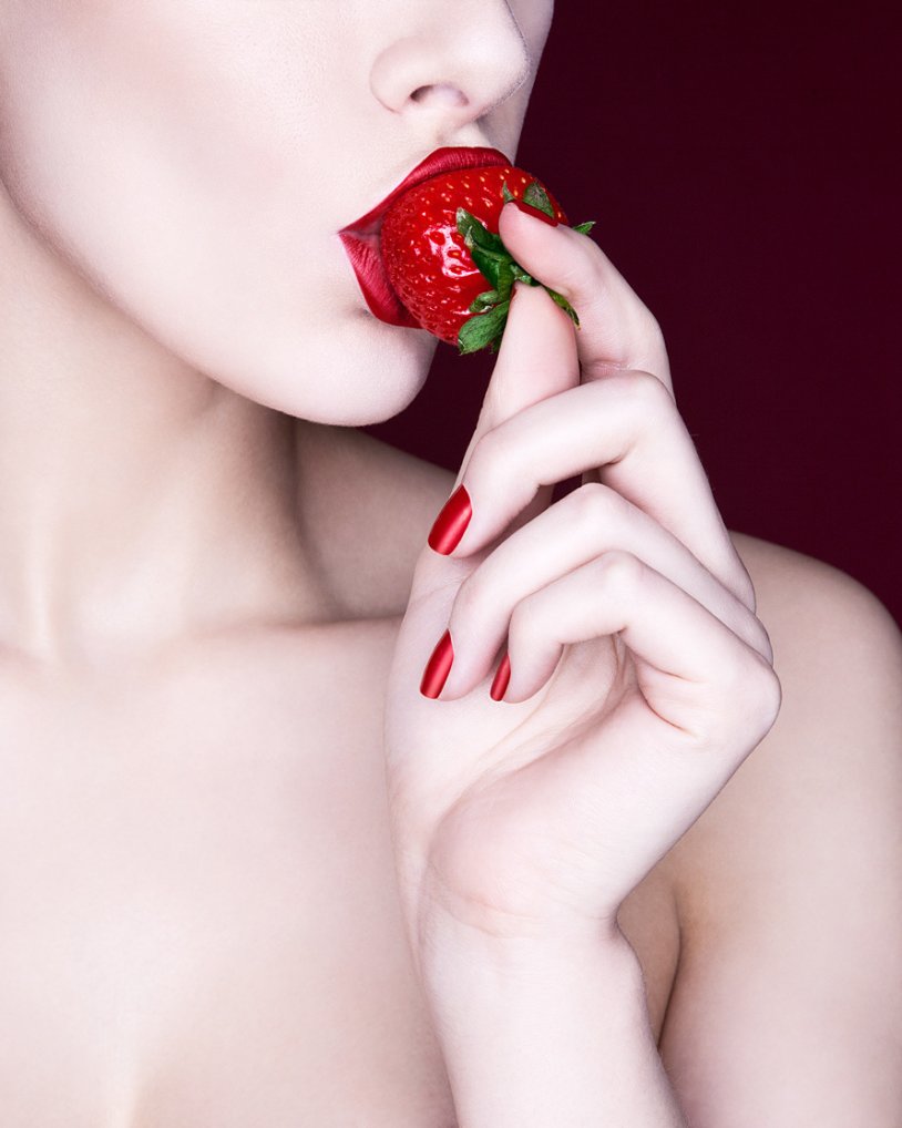 The girl eats strawberries