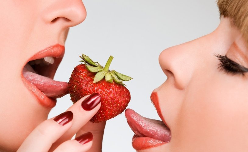 Female lips with strawberries