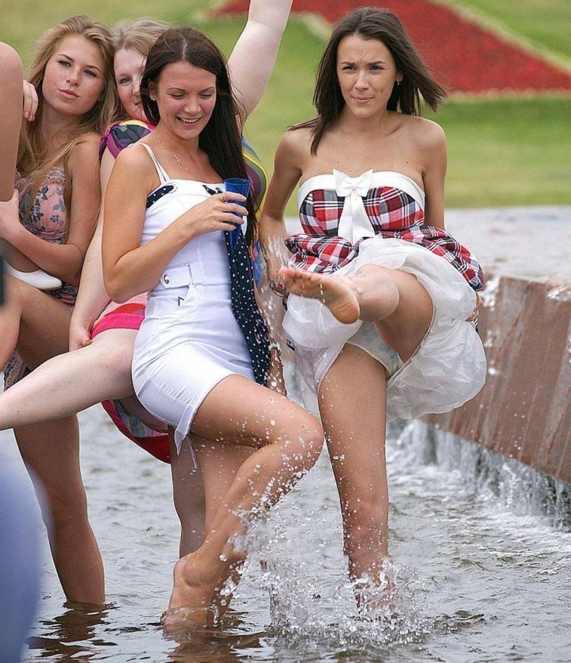 Graduates in the fountain in shorts