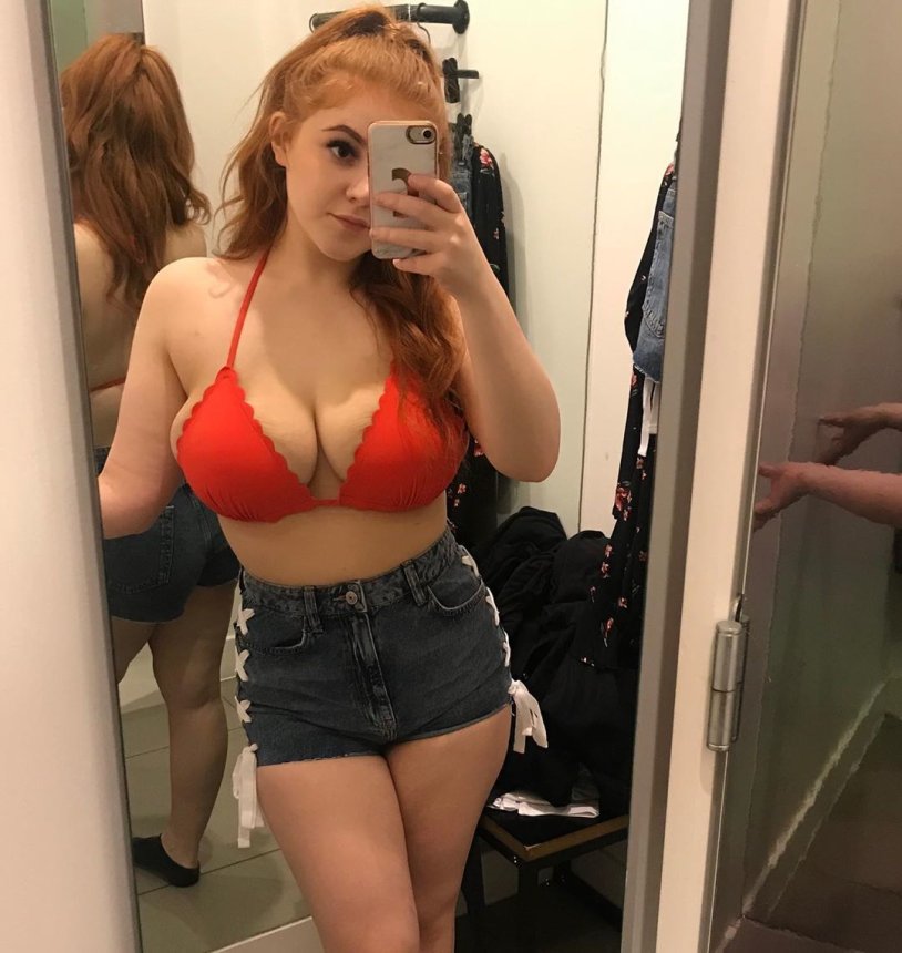 Girl with big breasts by the mirror