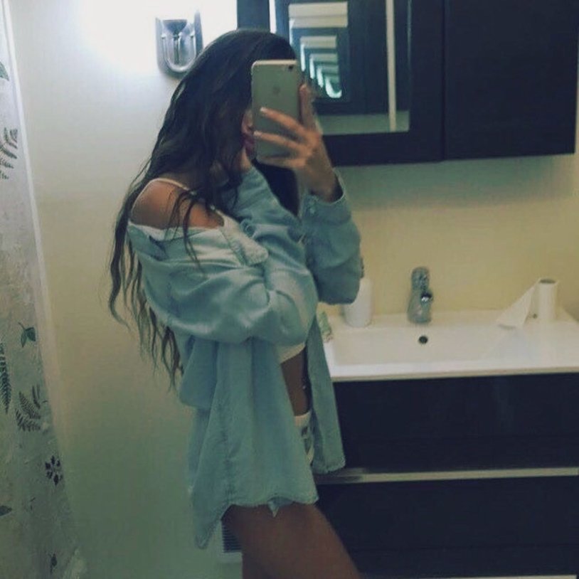 Brunette without a face at home