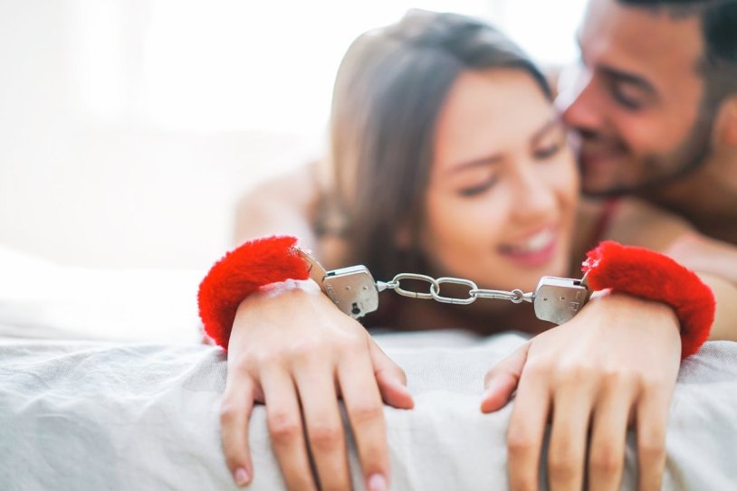 The handcuffs to the bed