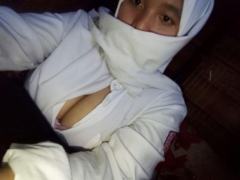 Girl in a hijab shows her chest