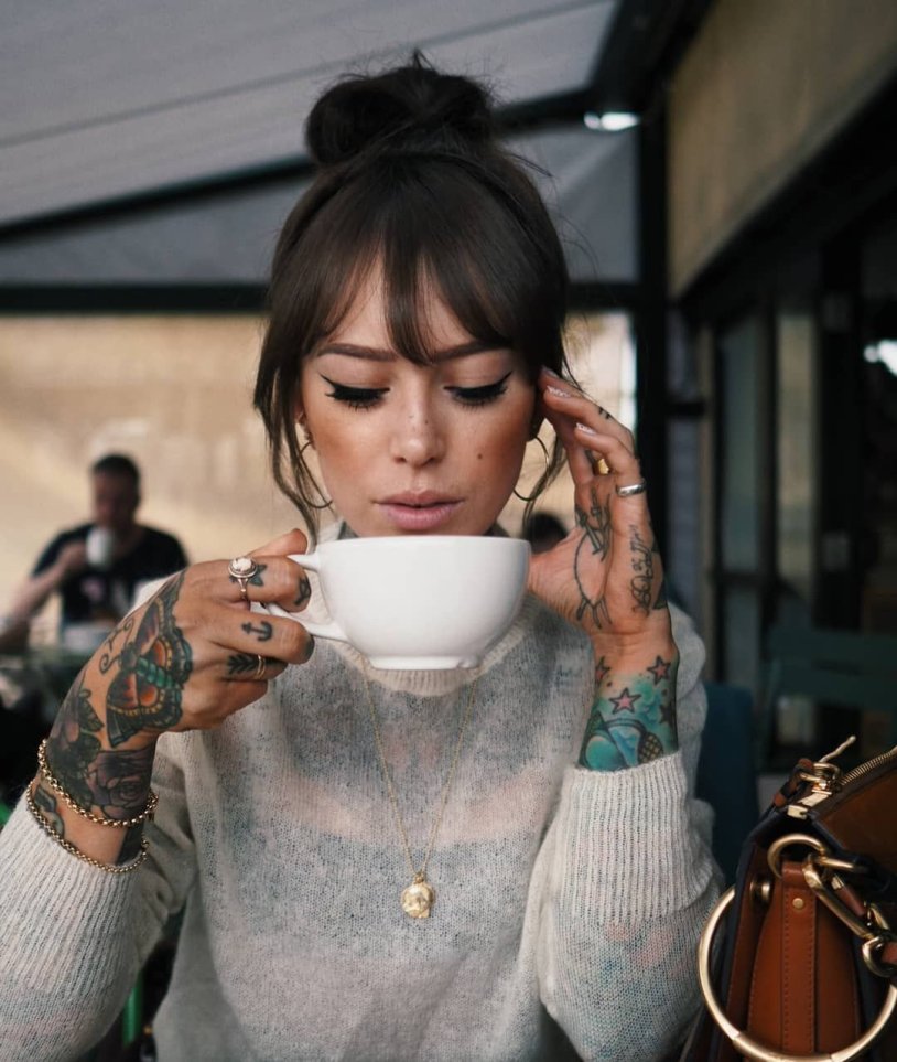 Tattooed girl with coffee