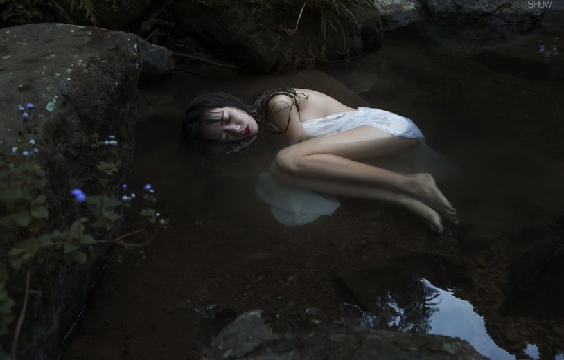 Girl lies in the river
