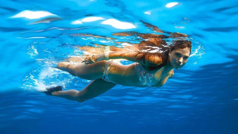 Girl swims under water
