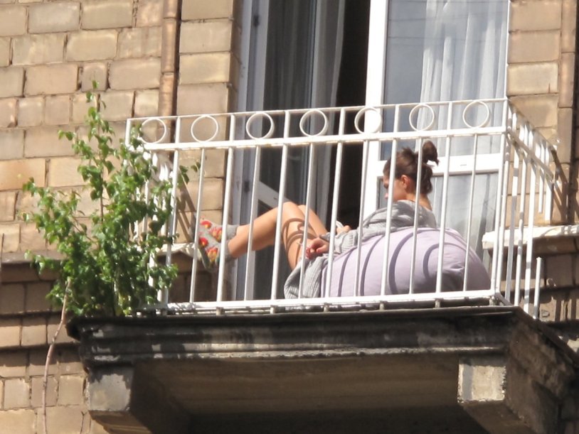 Girls sunbathe on the balcony