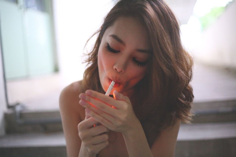 The girl smokes a cigarette