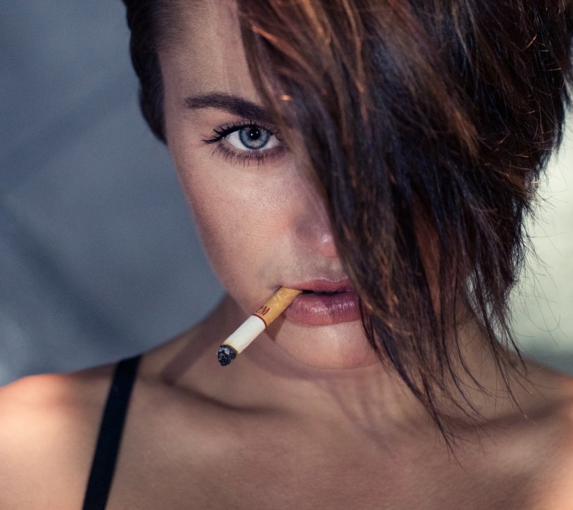 Beautiful girl with a cigarette in her mouth